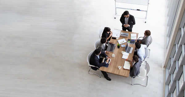 Office workers sitting around table