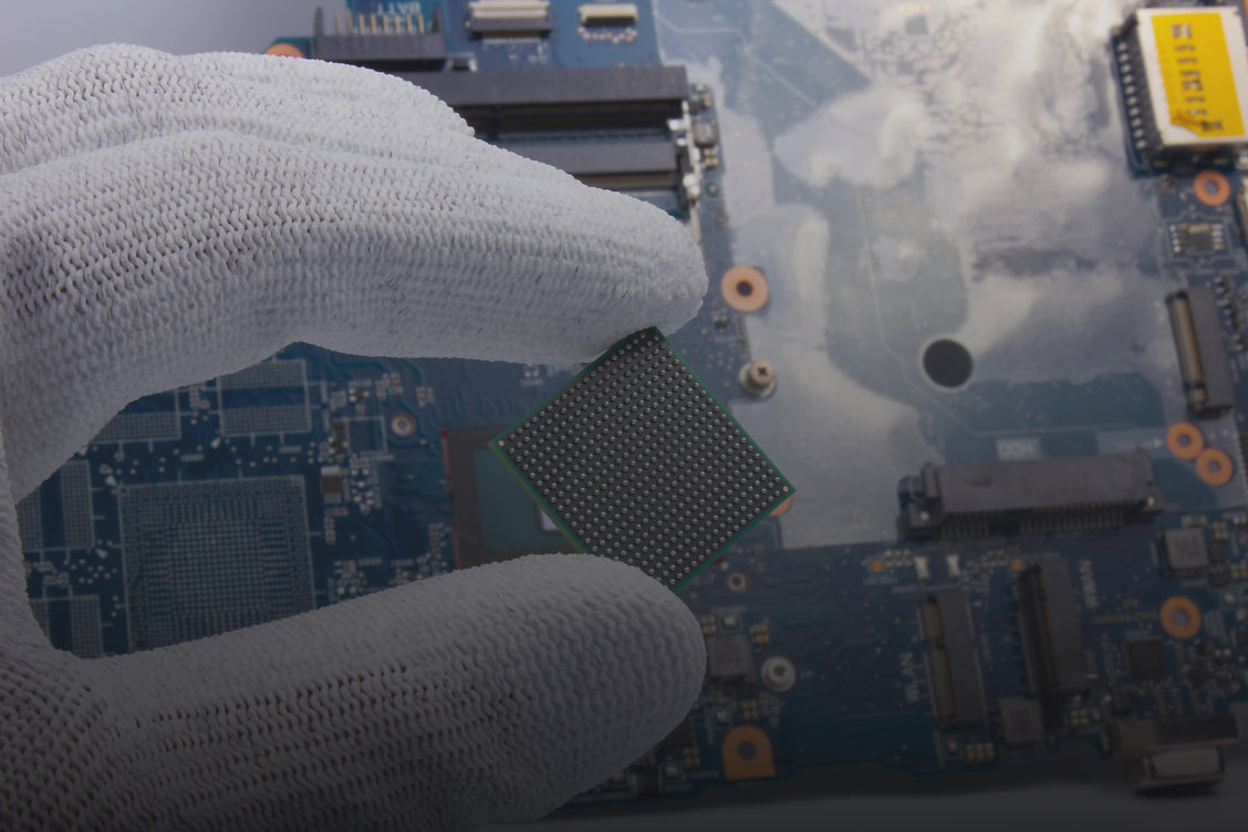  Gloved worker handling semiconductor chip